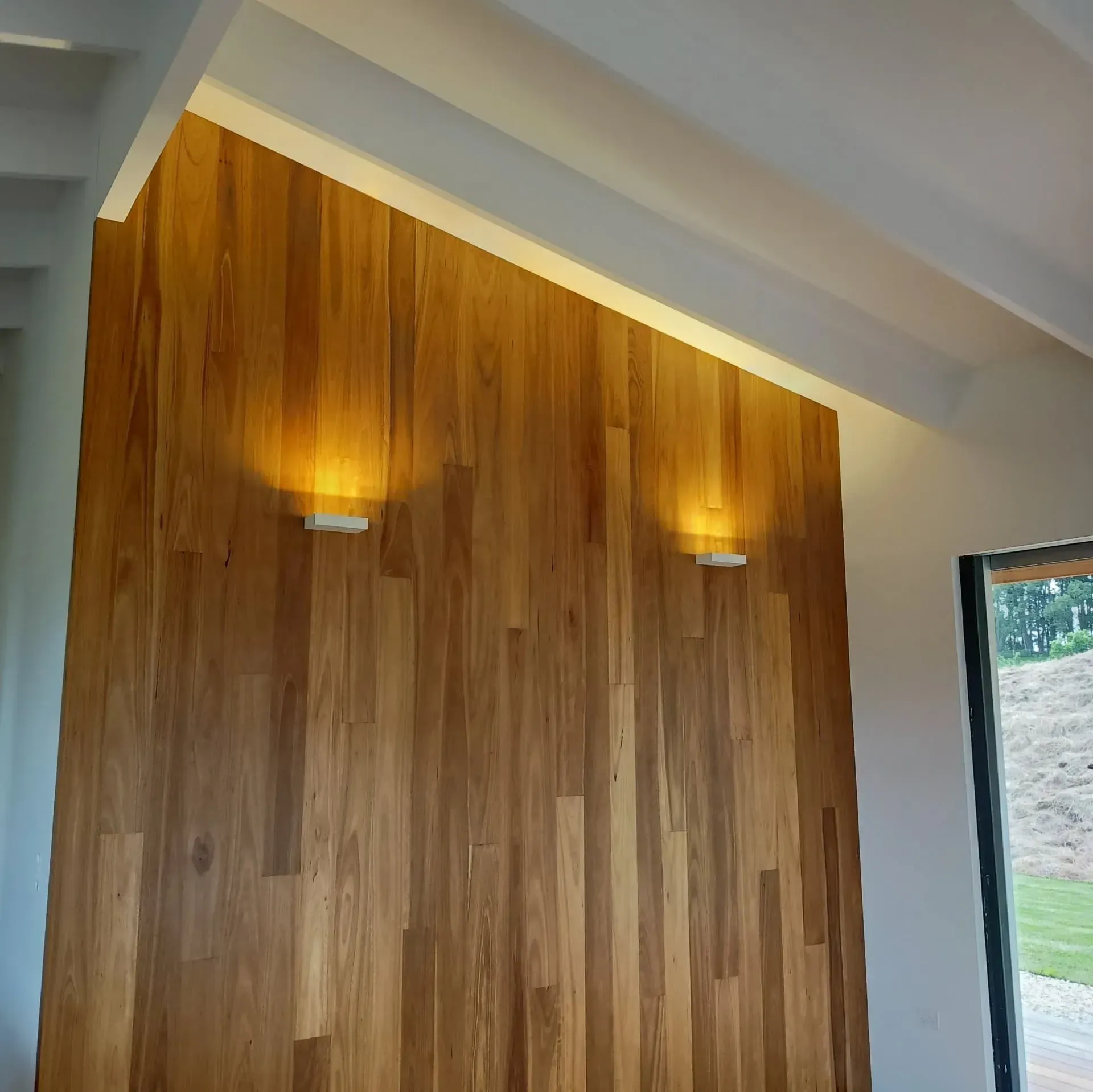A Wooden Wall With Two Lights on It — Bangalow Electrical in Bangalow, NSW