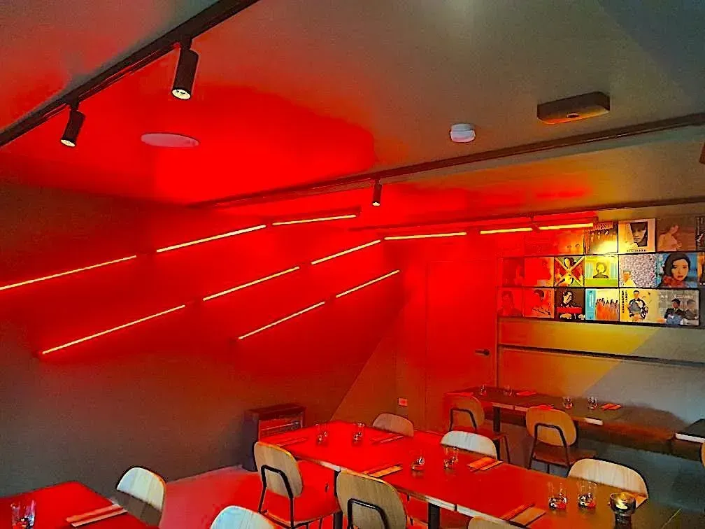 A Restaurant With Red Tables and Chairs and a Red Ceiling — Bangalow Electrical in Bangalow, NSW