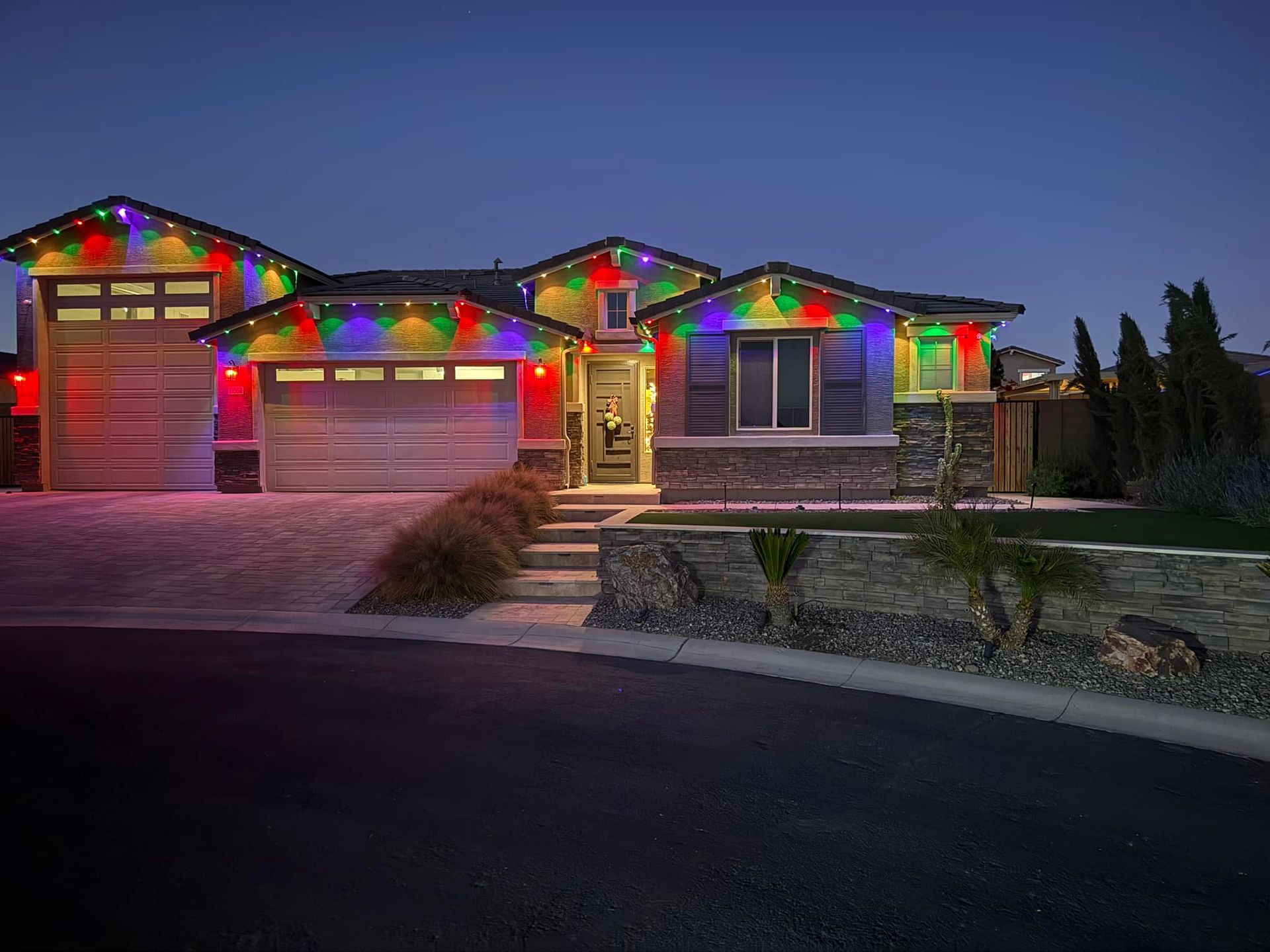 House decorated with red, green, and blue Christmas lights.