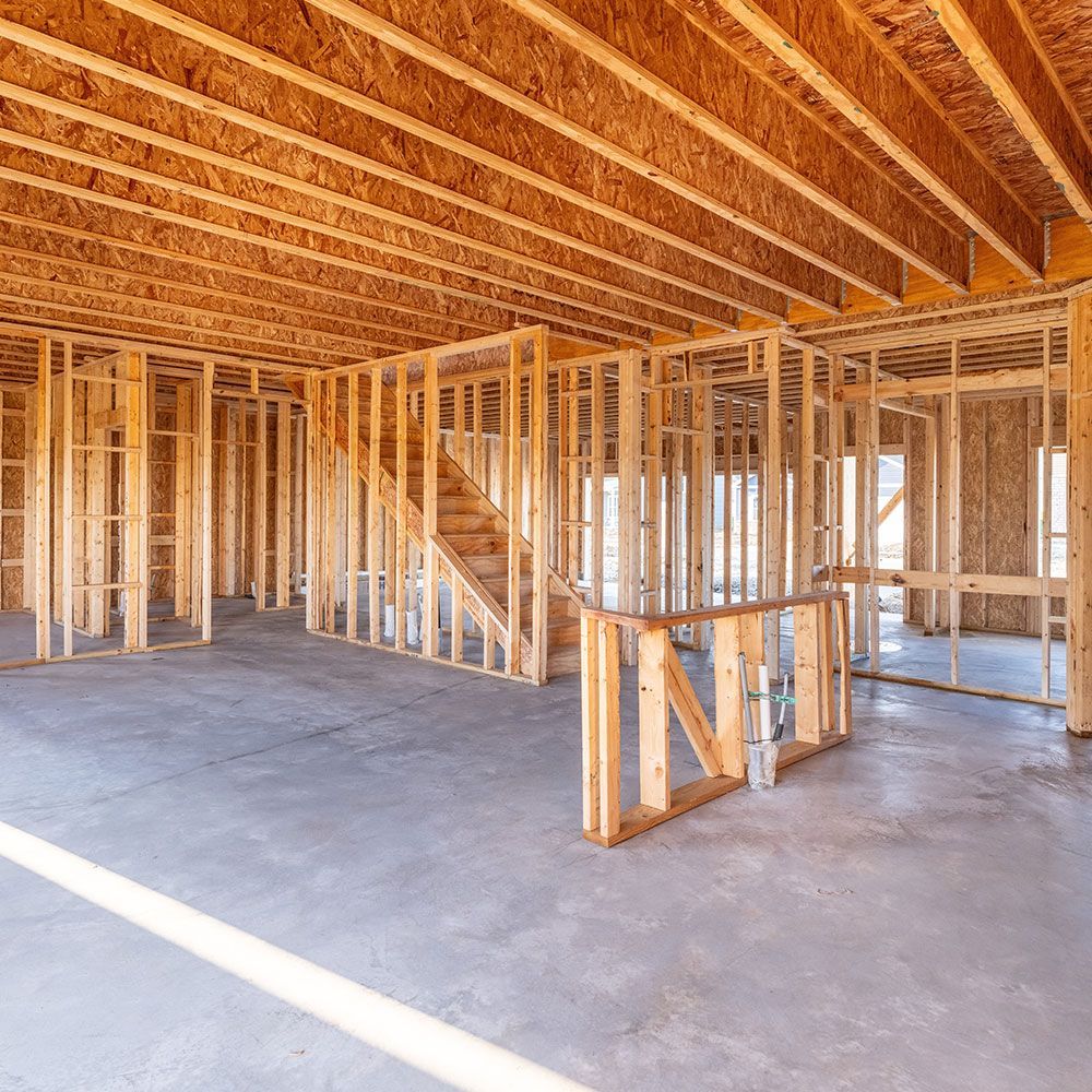 A house is being built with wooden beams and a staircase.