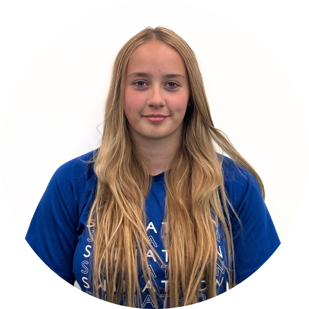 Young woman with long blonde hair, smiling, wearing a blue shirt.