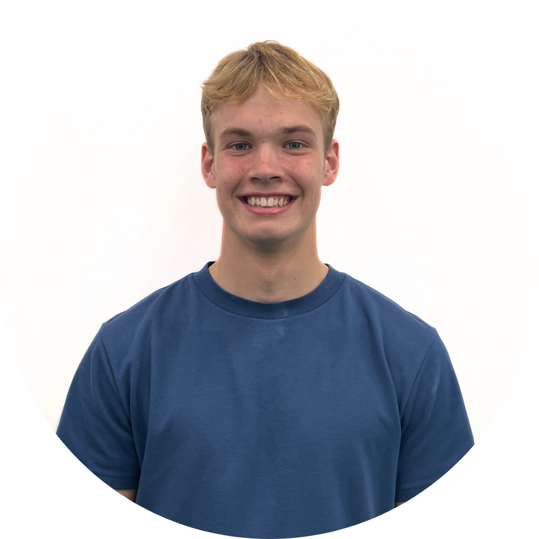 Young man with blonde hair, smiling broadly, wearing a blue shirt. Set against a white background.
