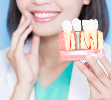 A woman is holding a sample Implant