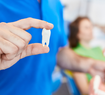 Man holding an extracted tooth