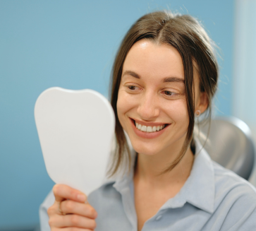Girl smiling in a small mirror