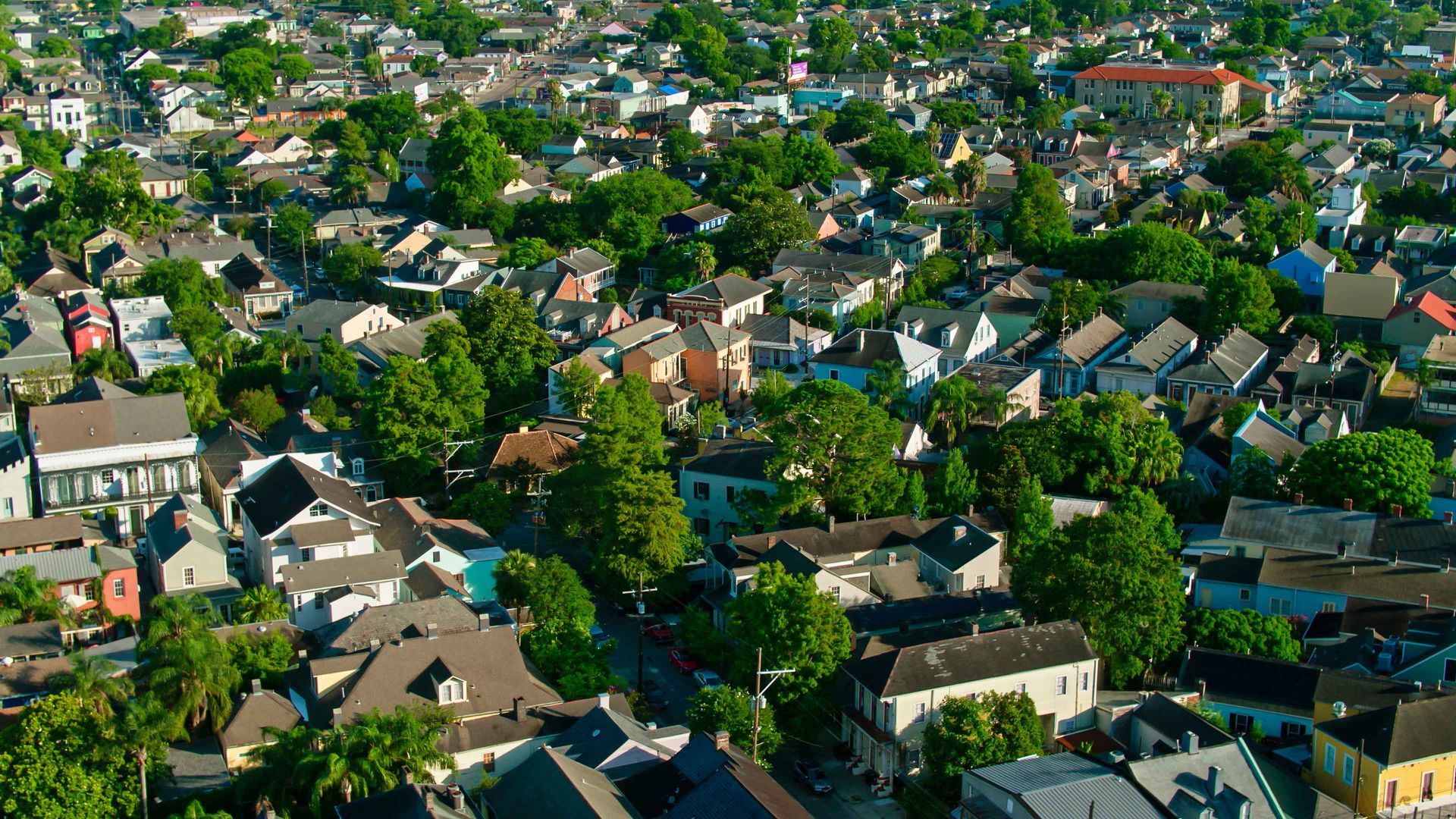 An aerial view of a residential area filled with lots of houses and trees.