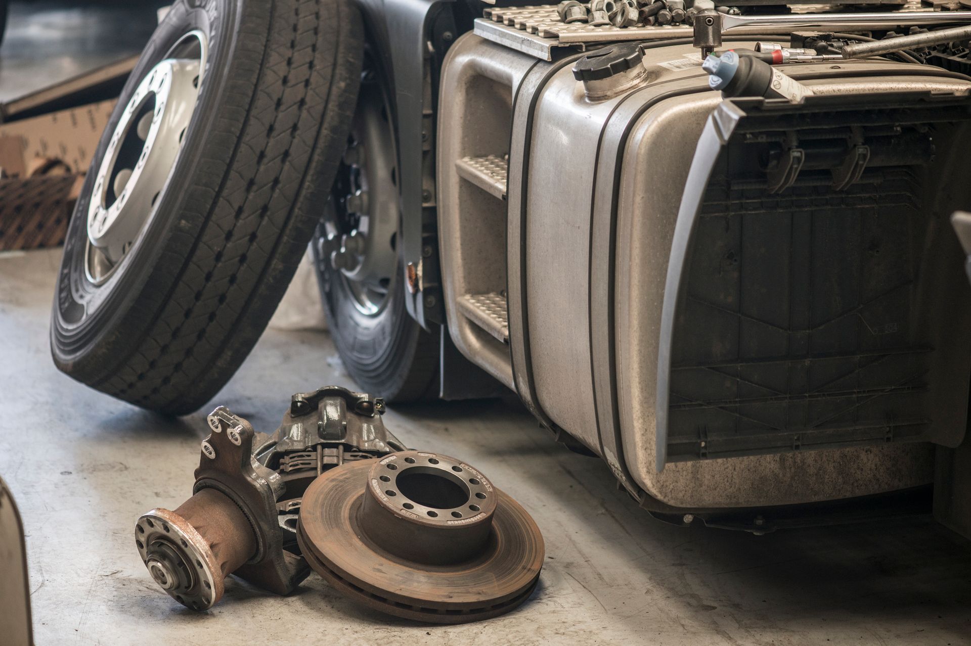 A disassembled truck with used truck parts around it. A disassembled truck with used truck parts around it.