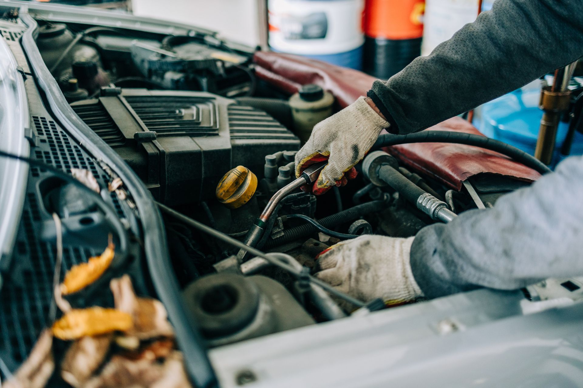 Close-up of a mechanic setting up a used engine in an auto repair shop Close-up of a mechanic setting up a used engine in an auto repair shop