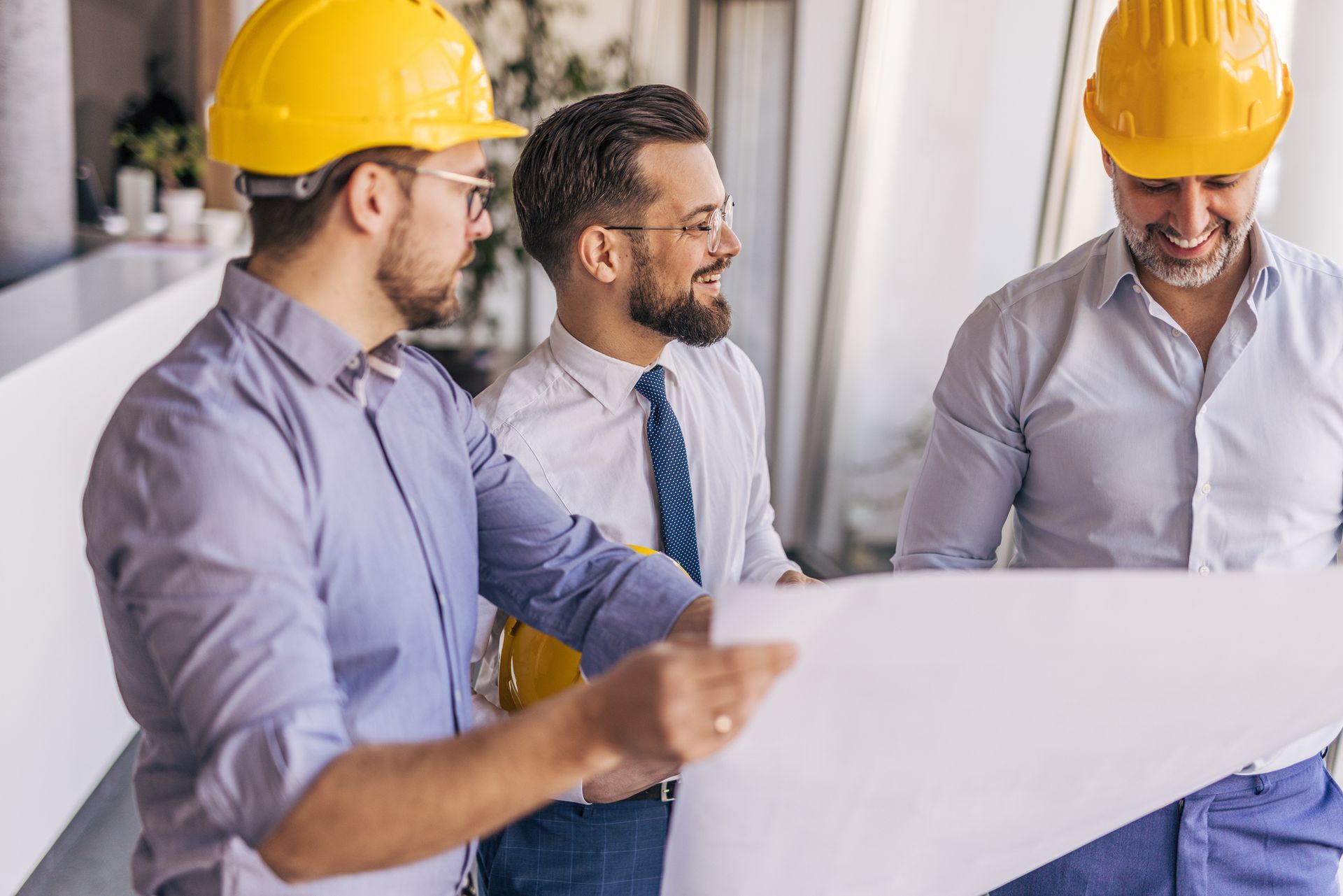 Engineers and architect discussing a blueprint in the office. Engineers and architect discussing a blueprint in the office.