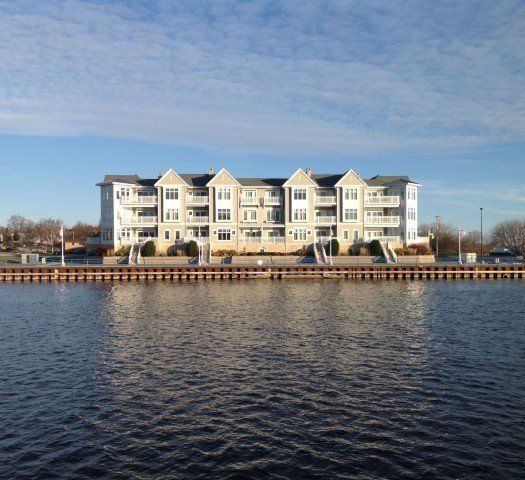 A Large White Building Sits Next to A Body of Water | Sheboygan, WI | Elite Builds