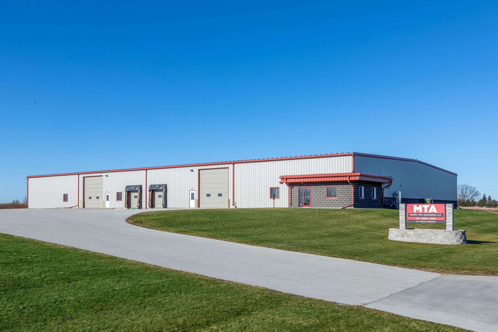 An Aerial View of A Factory with Smoke Coming out Of the Chimneys at Sunset | Sheboygan, WI | Elite Builds