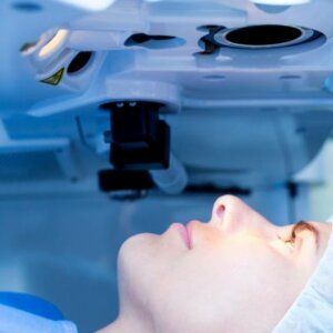 Caucasian woman in surgical gown and hairnet undergoing treatment from the best lasik surgeons in knoxville, tn 