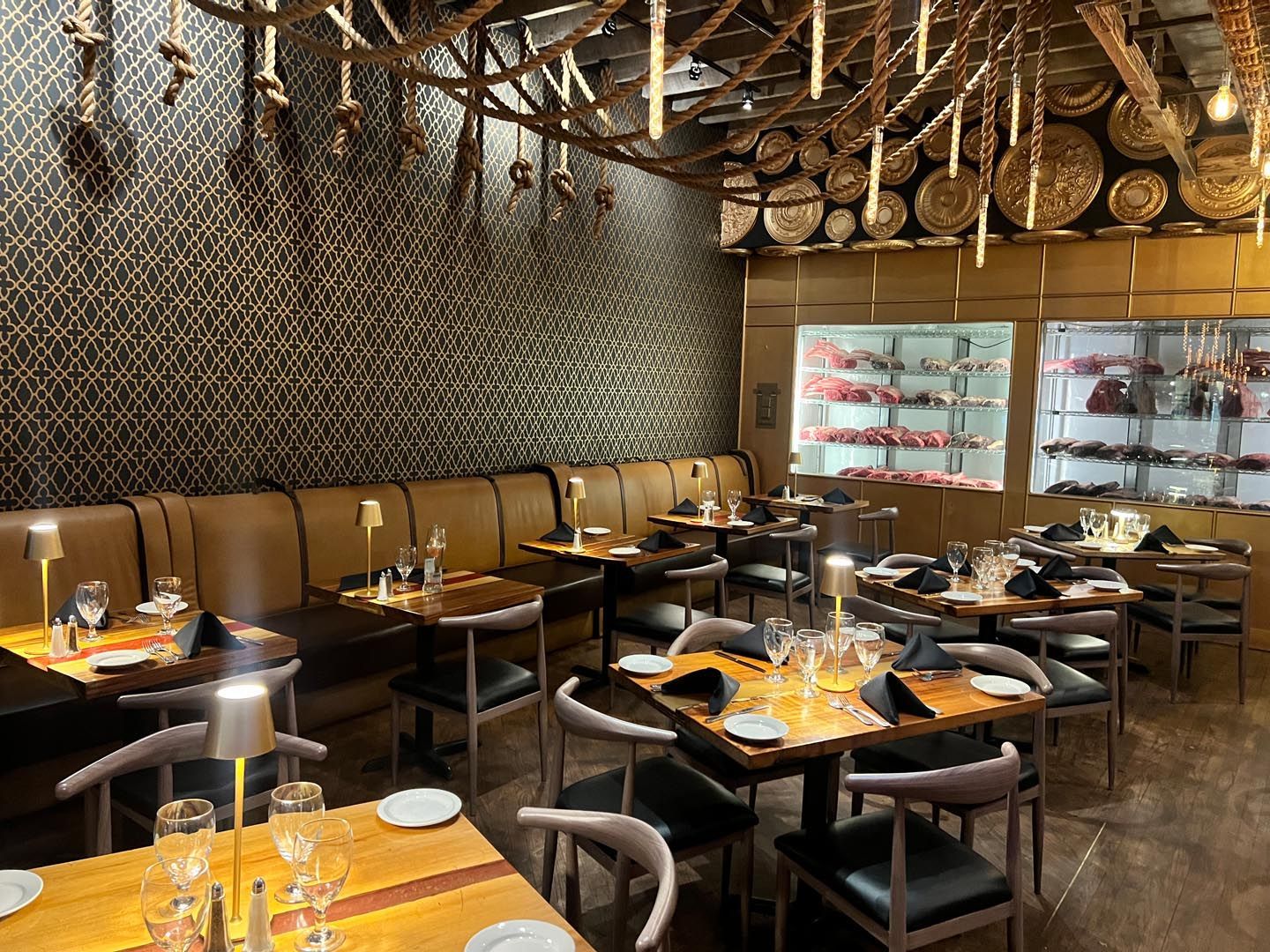 A restaurant with tables and chairs set up for dinner