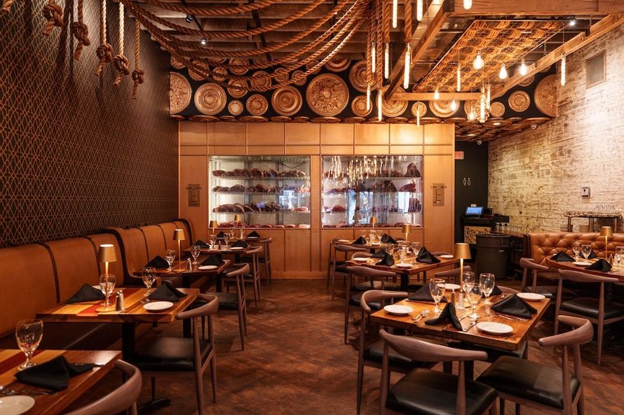 A restaurant filled with tables and chairs and plates on them.