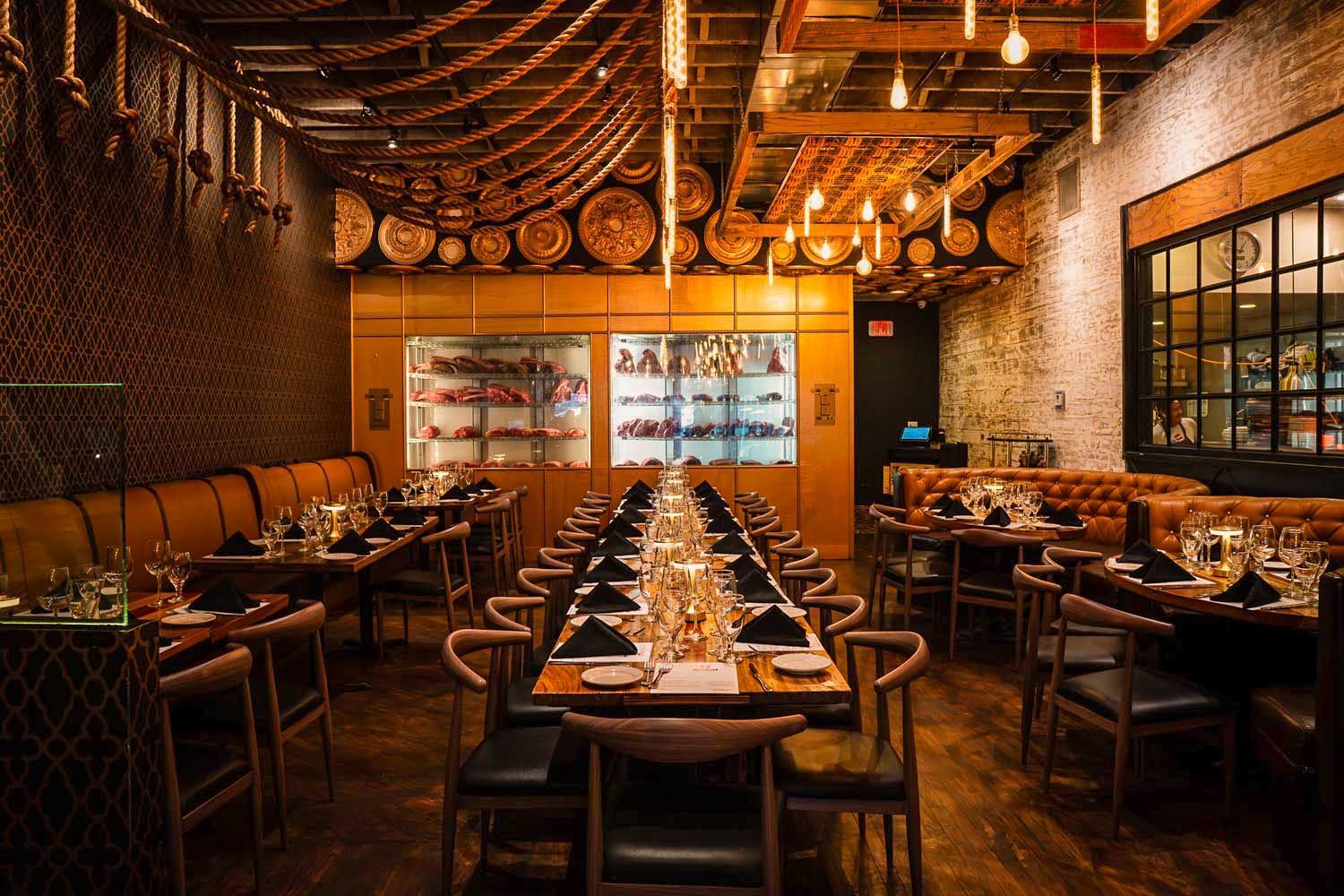 A large dining room with a long table and chairs.