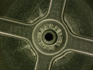 valve plate erosion due to contamination under microscope