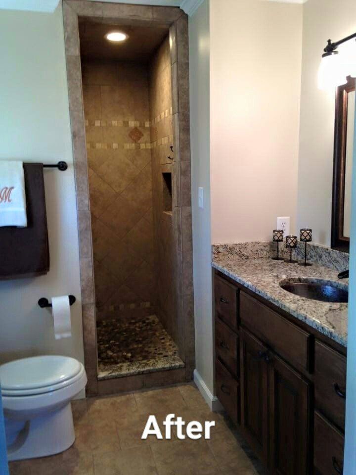 A bathroom with a toilet a sink and a walk in shower