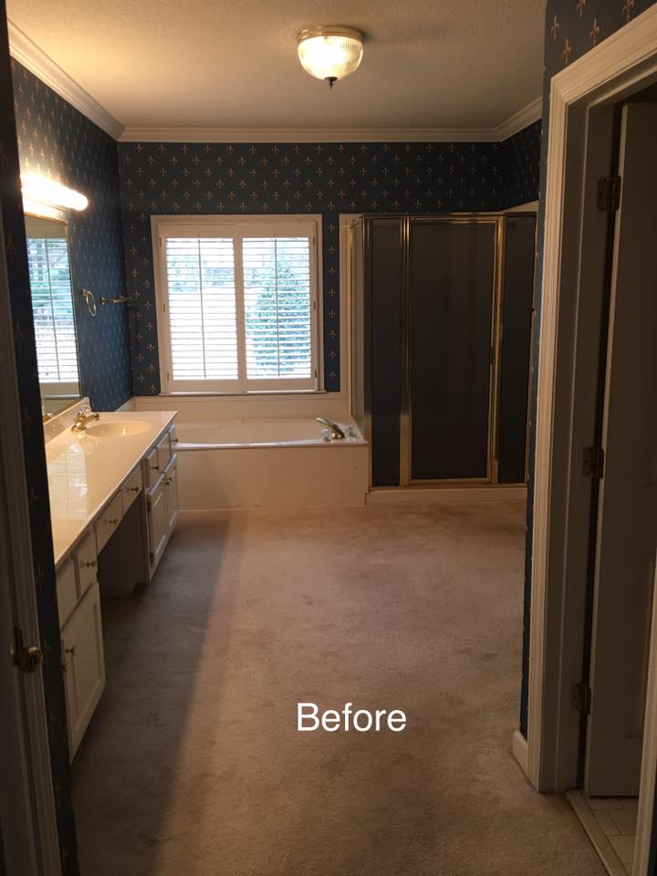 A bathroom with a tub , sink , mirror and shower before being remodeled.