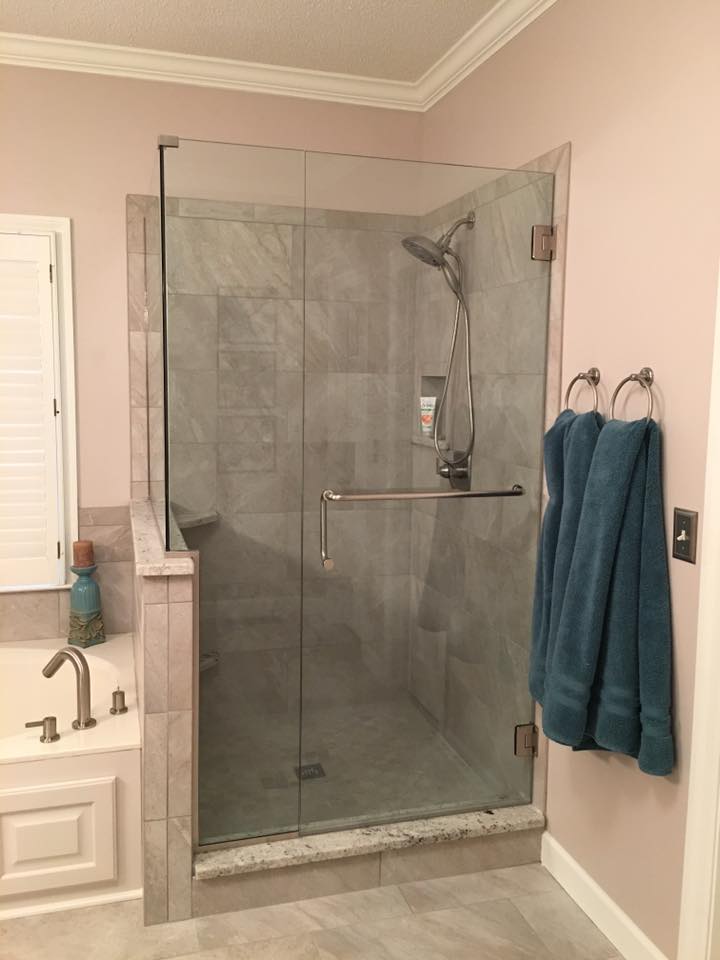 A bathroom with a walk in shower and a bathtub.