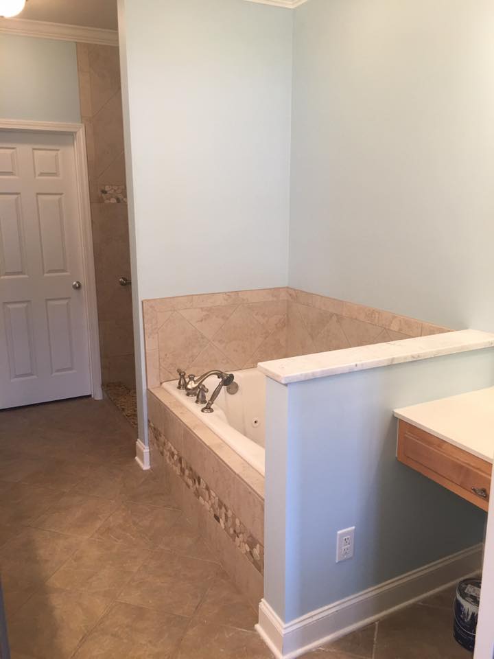 A bathroom with a jacuzzi tub and a sink.
