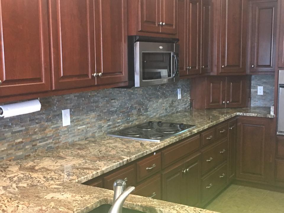 A kitchen with wooden cabinets and granite counter tops