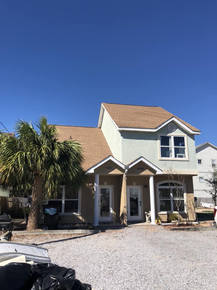 A house with a golf cart parked in front of it.