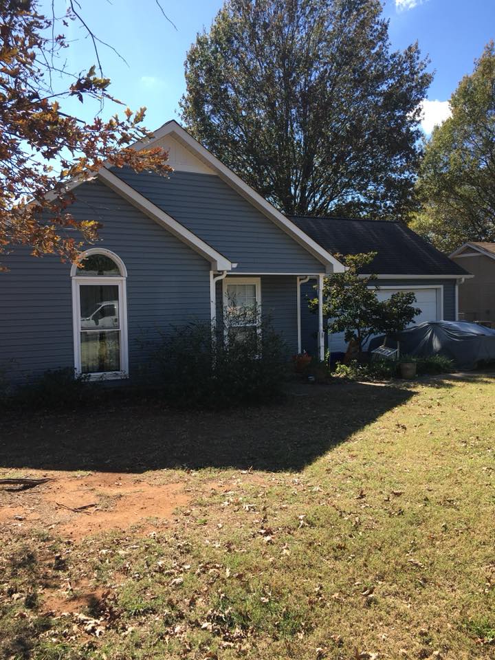 A house with a car parked in front of it