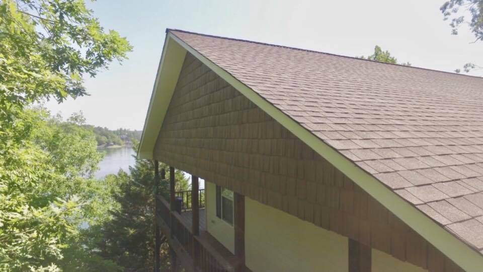 The roof of a house with a view of a lake