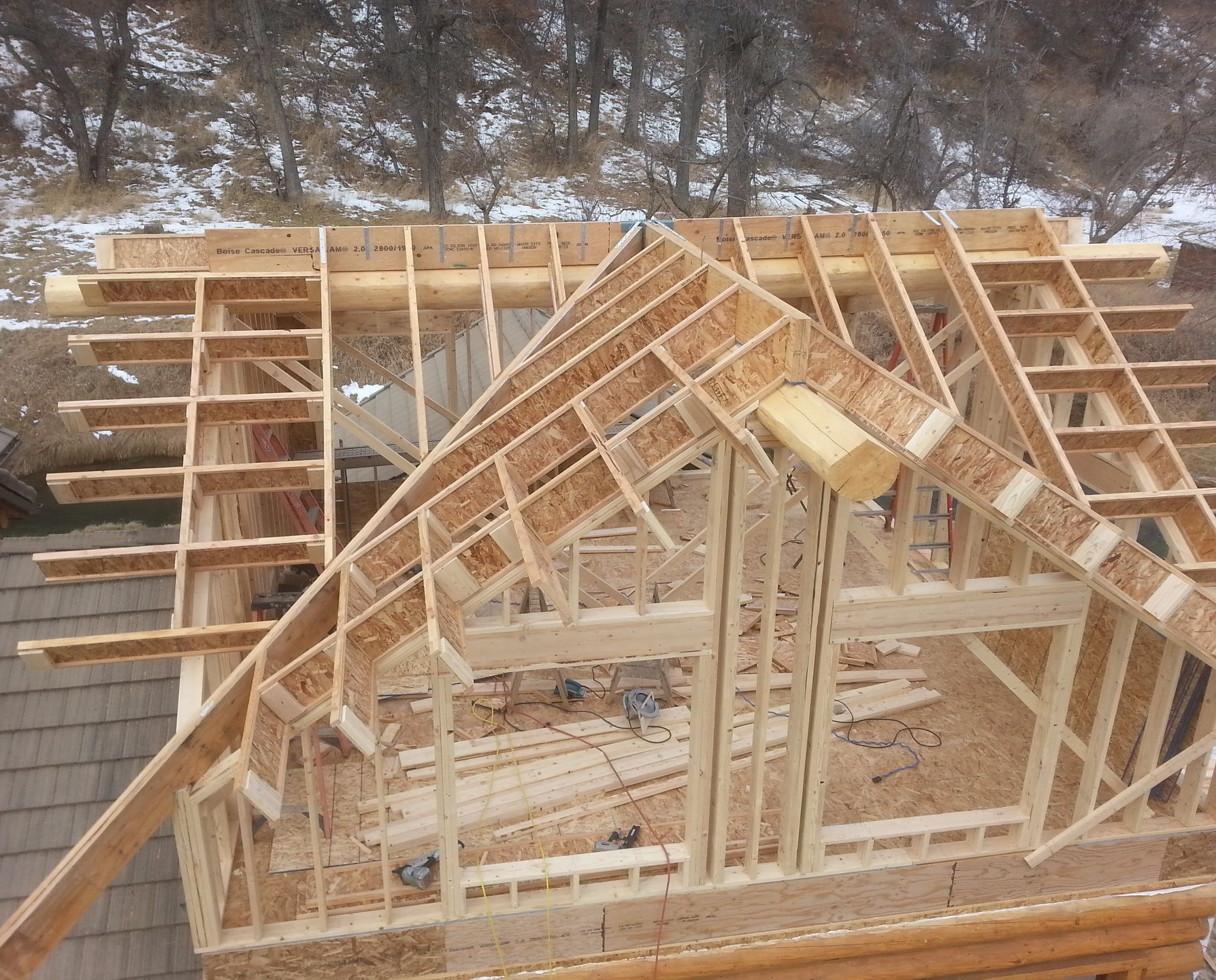 A construction worker is standing in a room under construction.