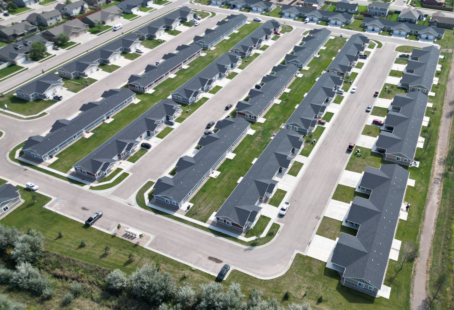 A building under construction with a crane in front of it.