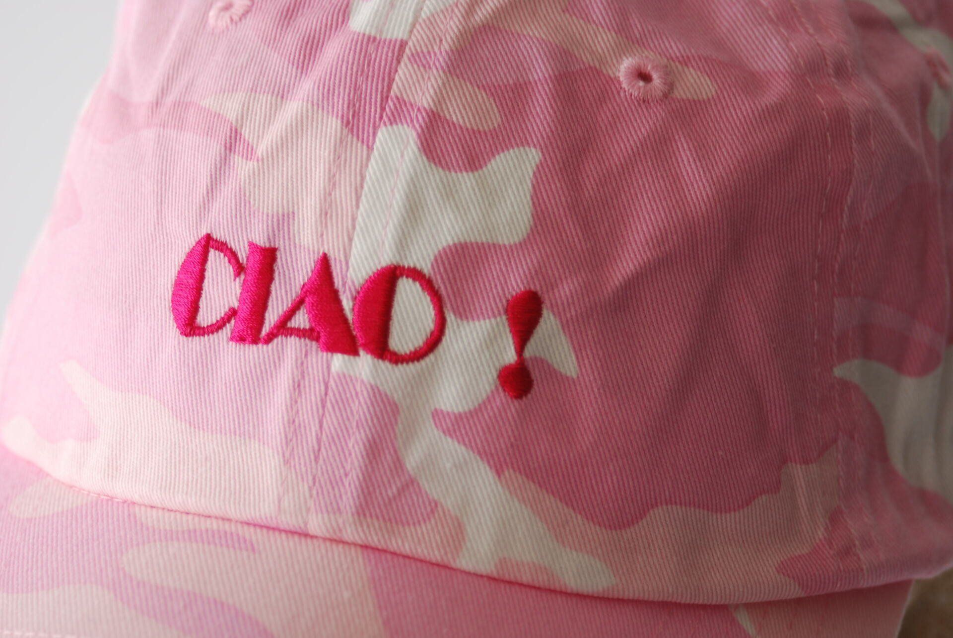 A pink camo hat with the word CIAO embroidered on it