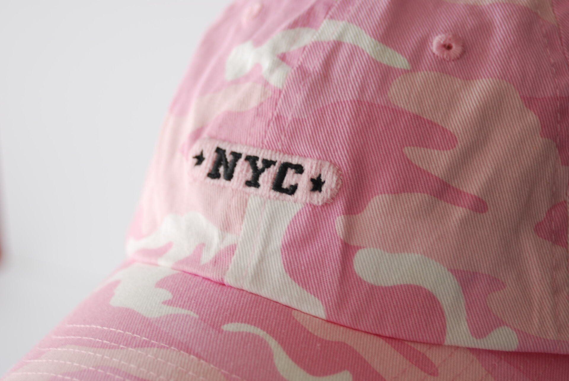 Close up of a pink camo baseball cap with NYC embroidered on it
