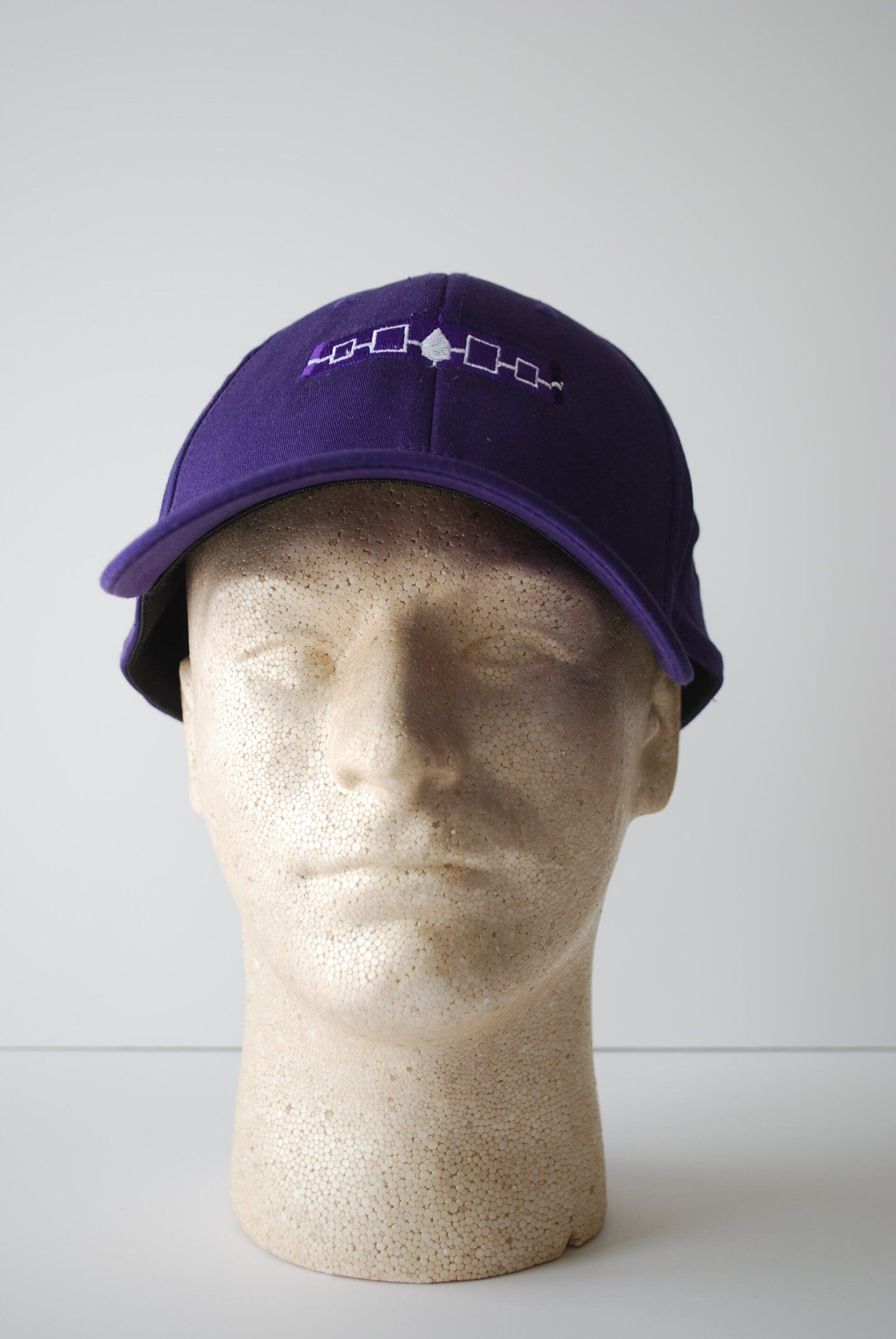 A purple hat on a mannequin head