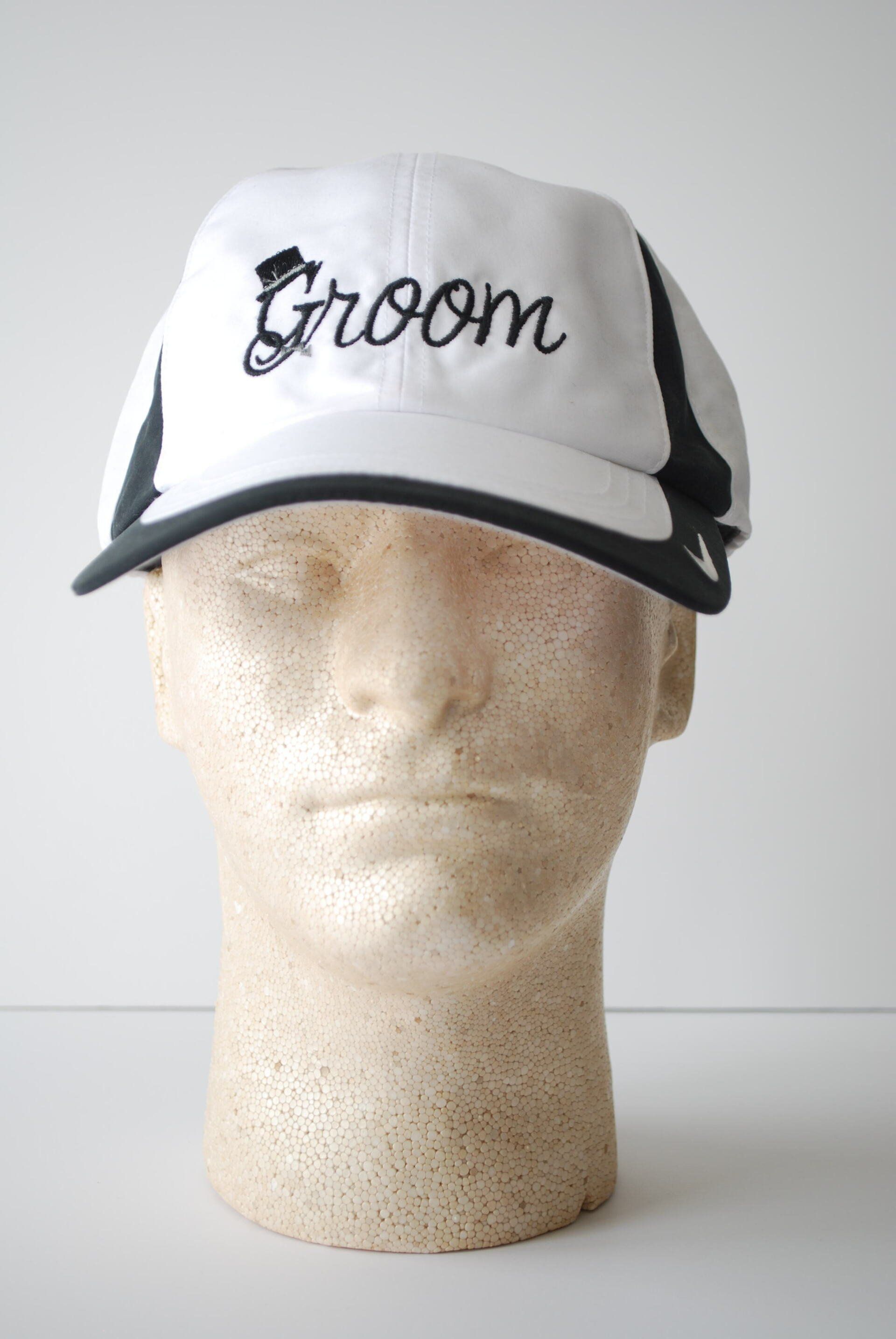 A black and white hat with the word Groom embroidered on it