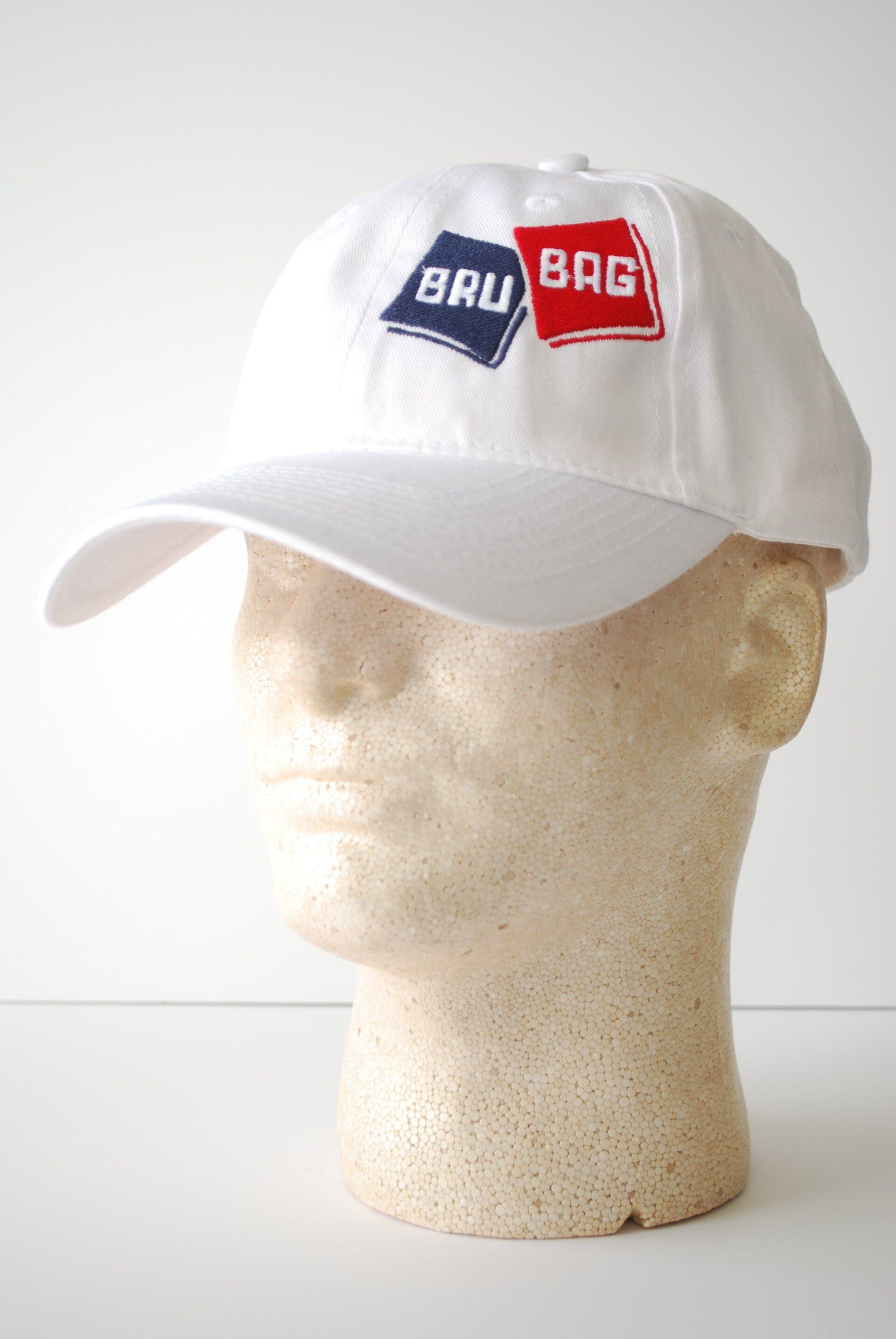 A white baseball cap on a mannequin head with Bru Bag's logo embroidered on it