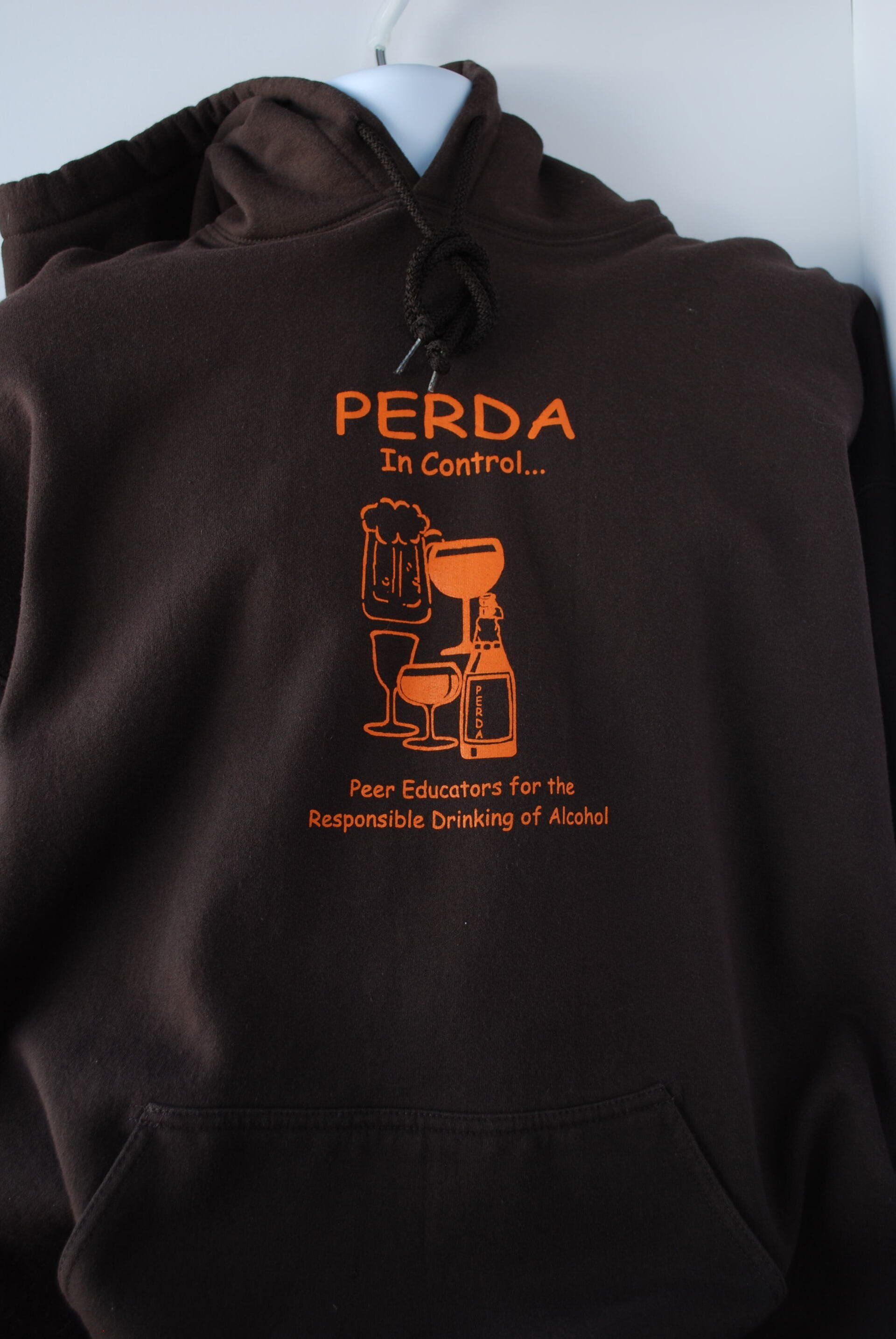 A brown hoodie that says PERDA on it