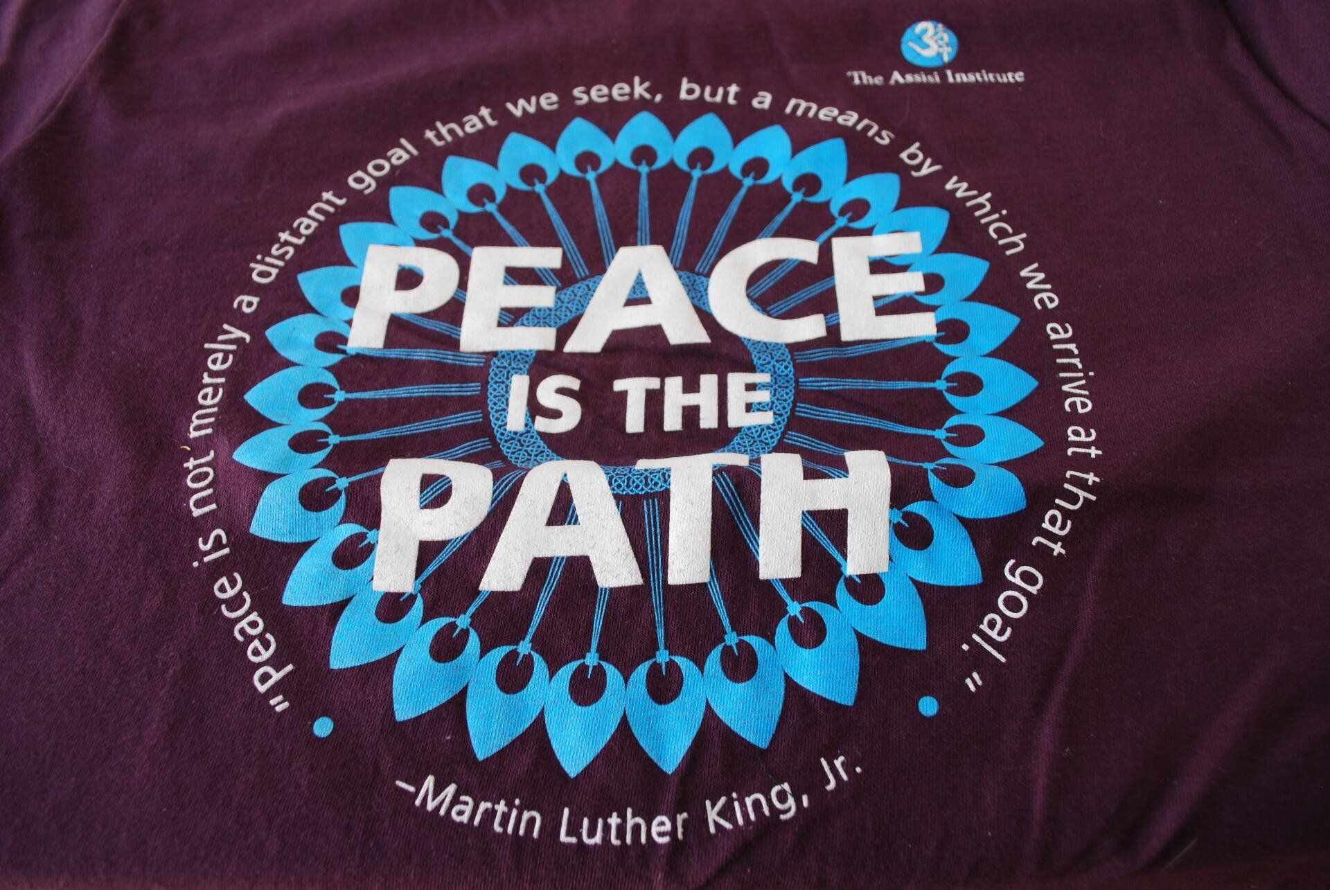 A purple shirt that says peace is the path