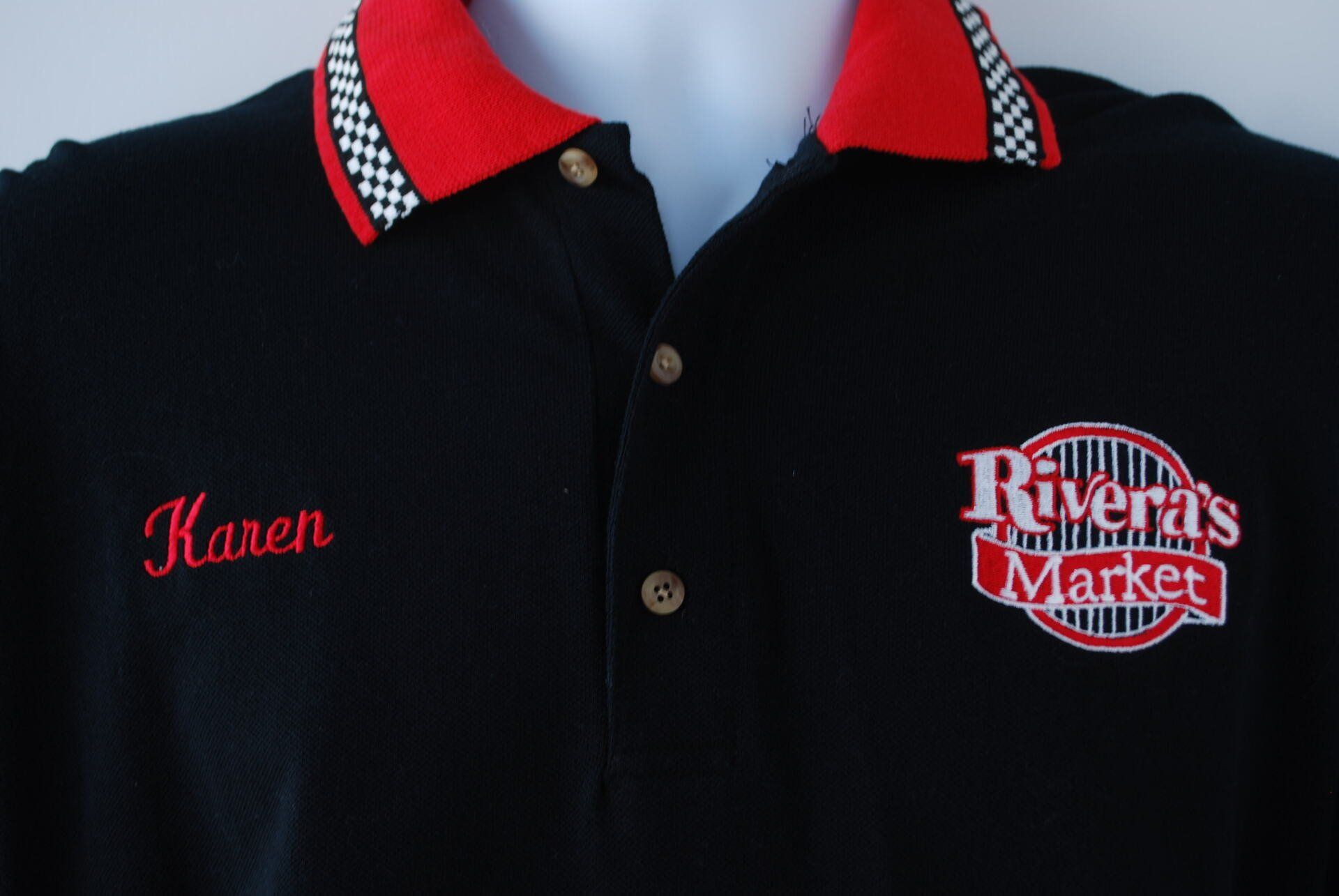 A black shirt with Rivera 's Market embroidered on it