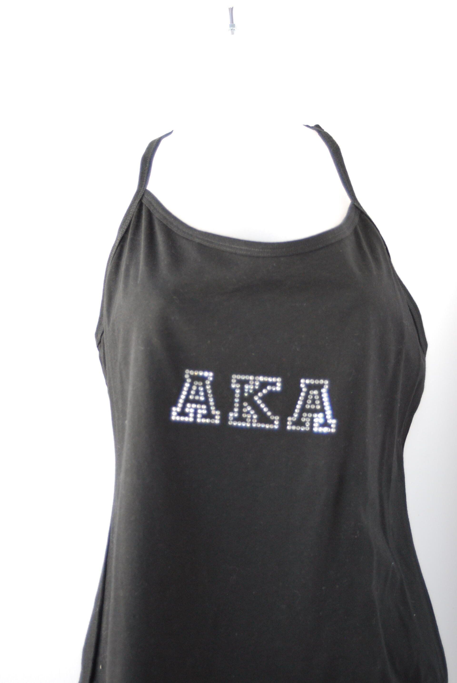 A black tank top with the letters AKA on it