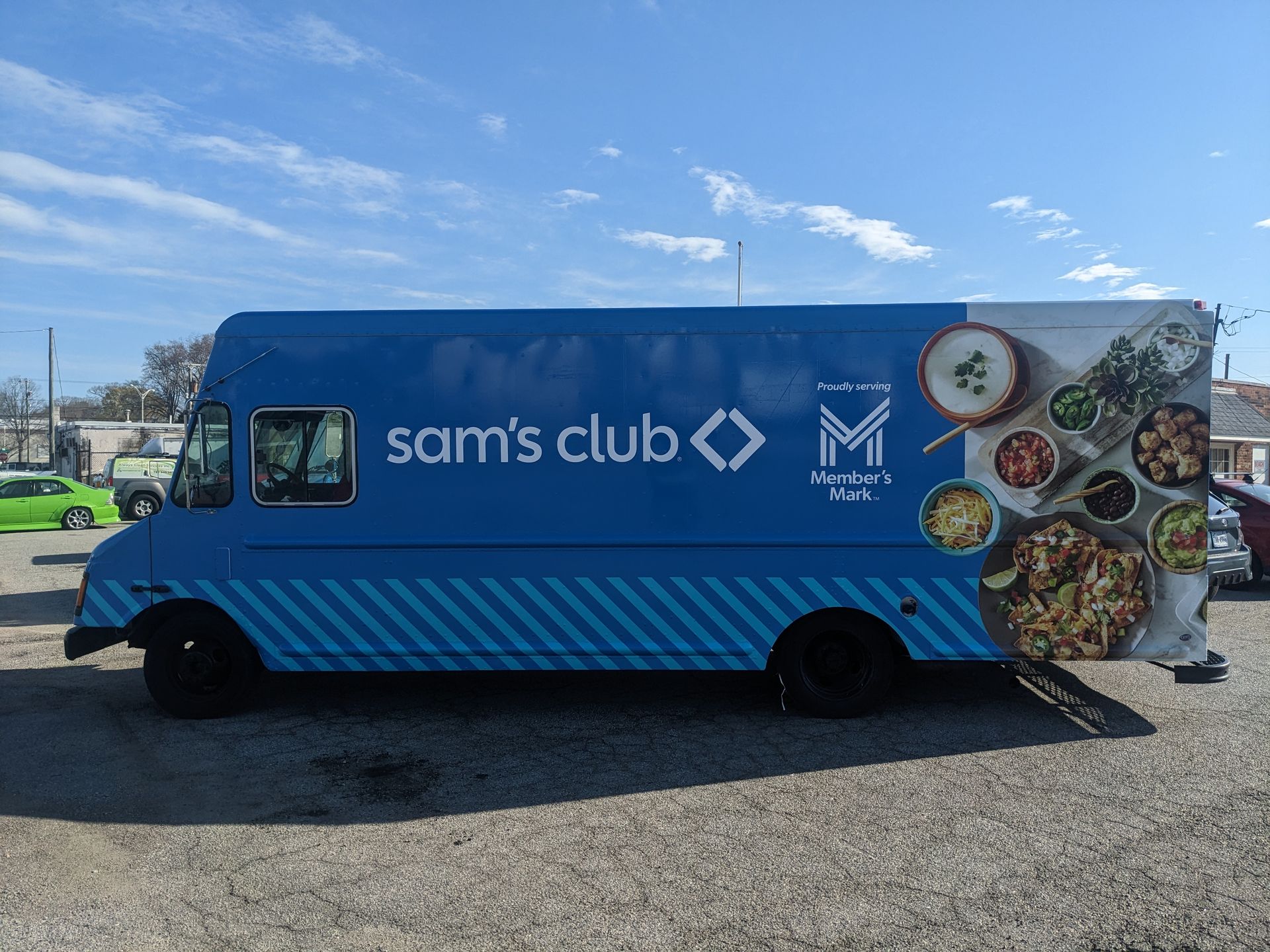 Hyundai car dealership interior with cars on display and promotional posters.