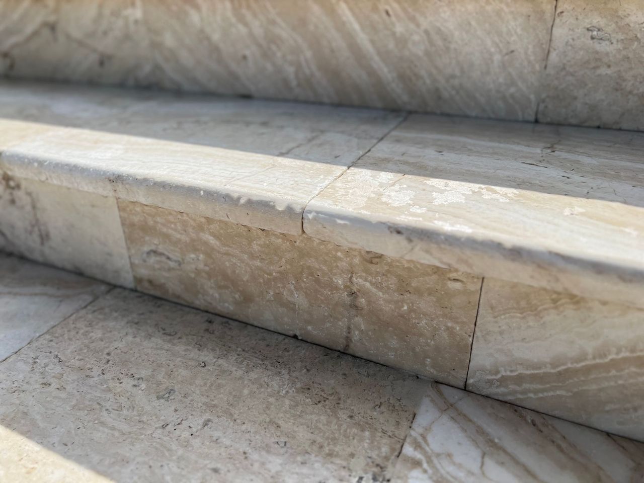 A close up of a set of stairs made of natural stone.
