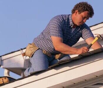 Man repairing roof - roofing in West Congers, NY