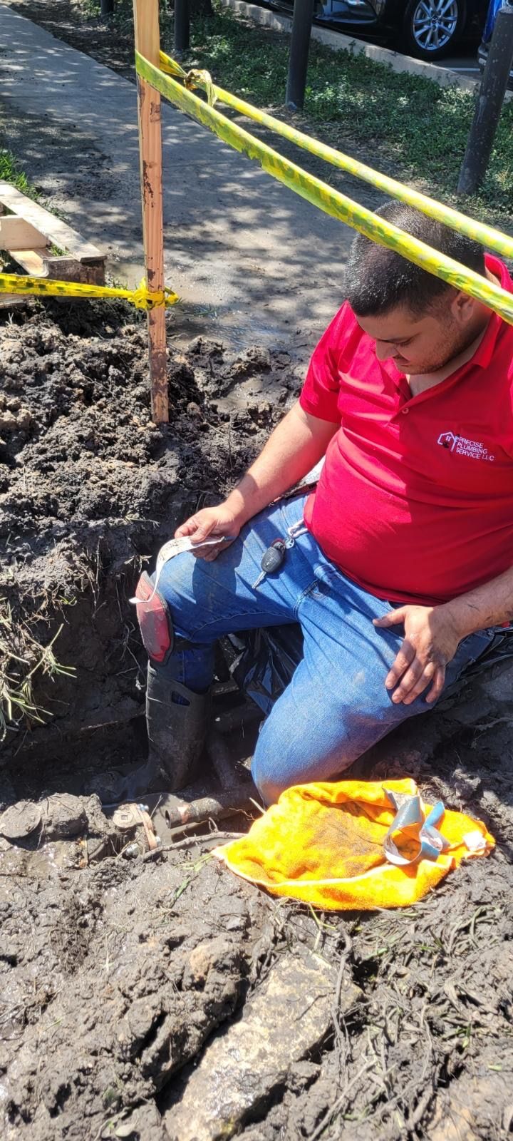 Team member of precise plumbing and air digging a hole to installing the pipes for plumbing. 