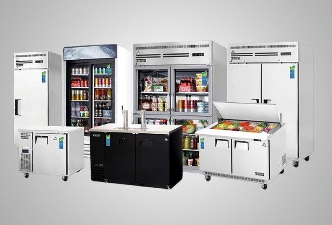 Stainless steel storage room with shelves and double doors. Fluorescent lights illuminate the space.