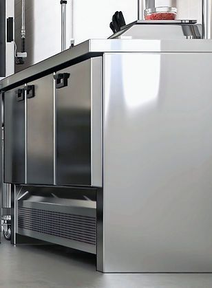 Stainless steel commercial refrigerator unit. Two door cabinets, bottom vent, kitchen setting. Stainless steel commercial refrigerator unit. Two door cabinets, bottom vent, kitchen setting.