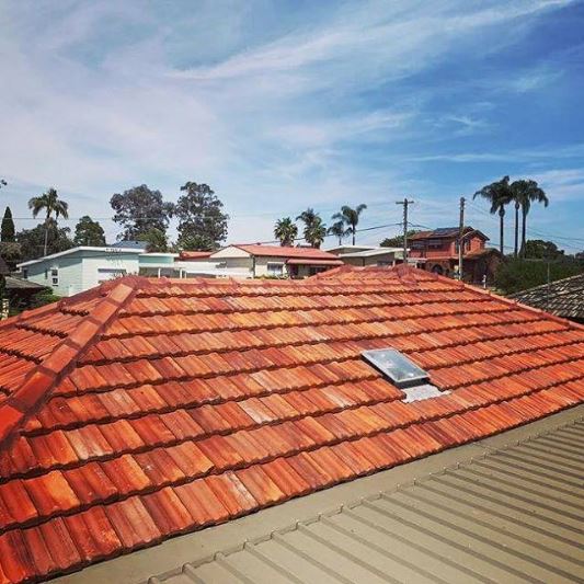 red tile roof with skylight