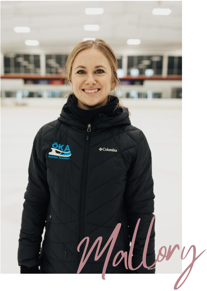 Woman smiling, wearing a black jacket, standing on an ice rink. 