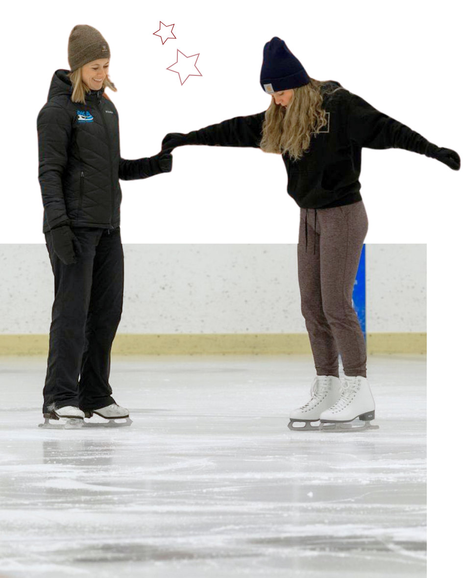 Two ice skaters holding hands, practicing on ice. One wears black jacket, the other a grey top. White ice rink.