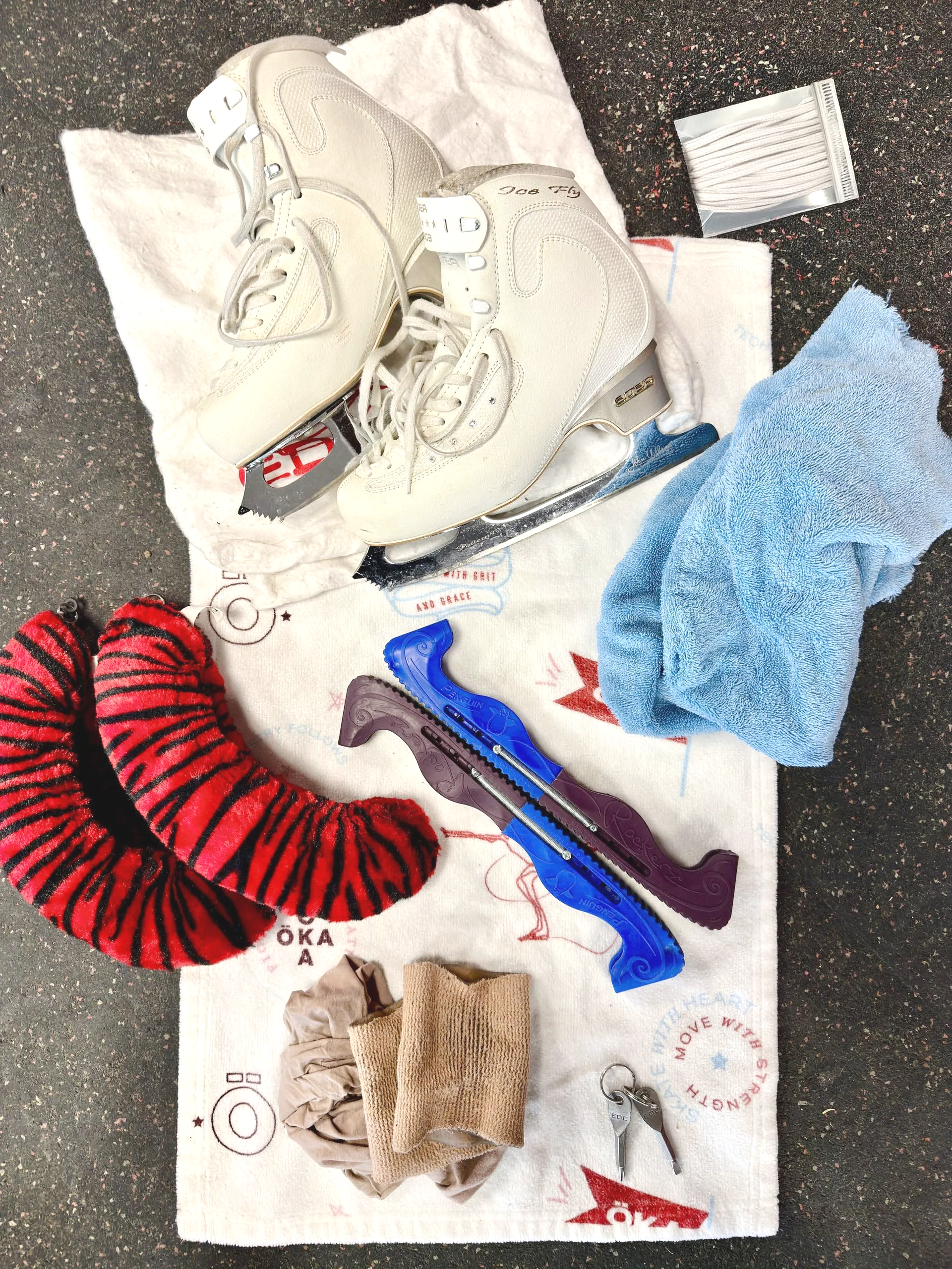 Ice skates with colorful blade guards, indoors.