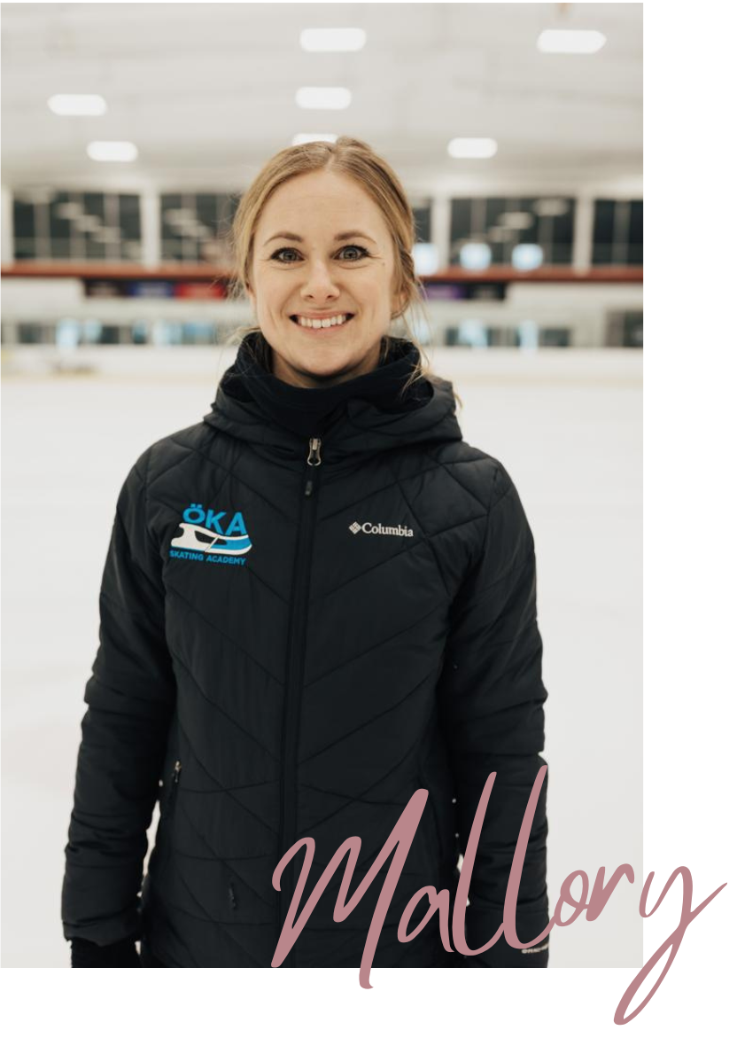 Woman in black jacket on ice rink, smiling. 